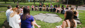 Large group of students meeting at the "eye" sculpture Hero